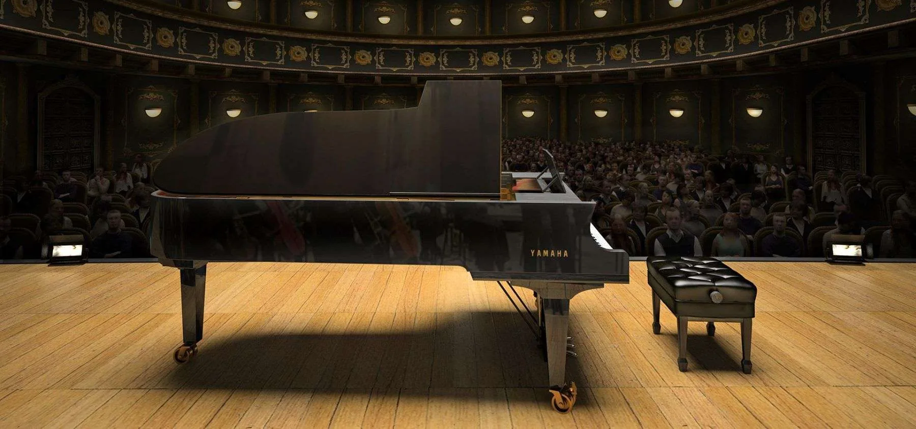 A polished Yamaha concert grand on a wooden stage in front of a full auditorium